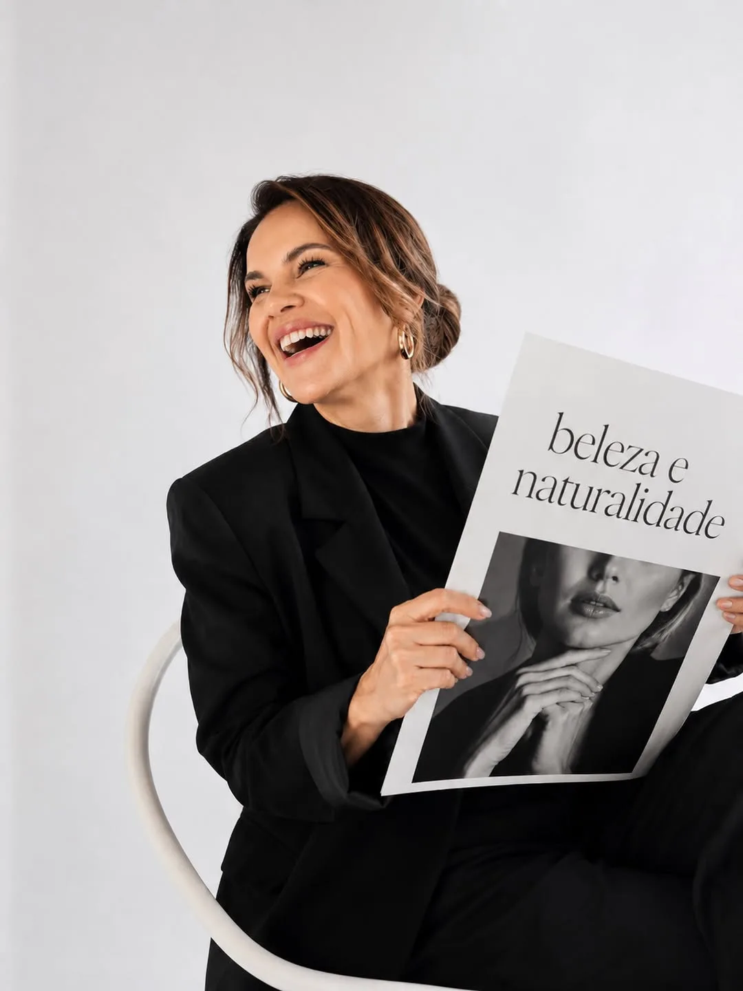 Dra. Ana Cláudia segurando um editorial sobre beleza e naturalidade